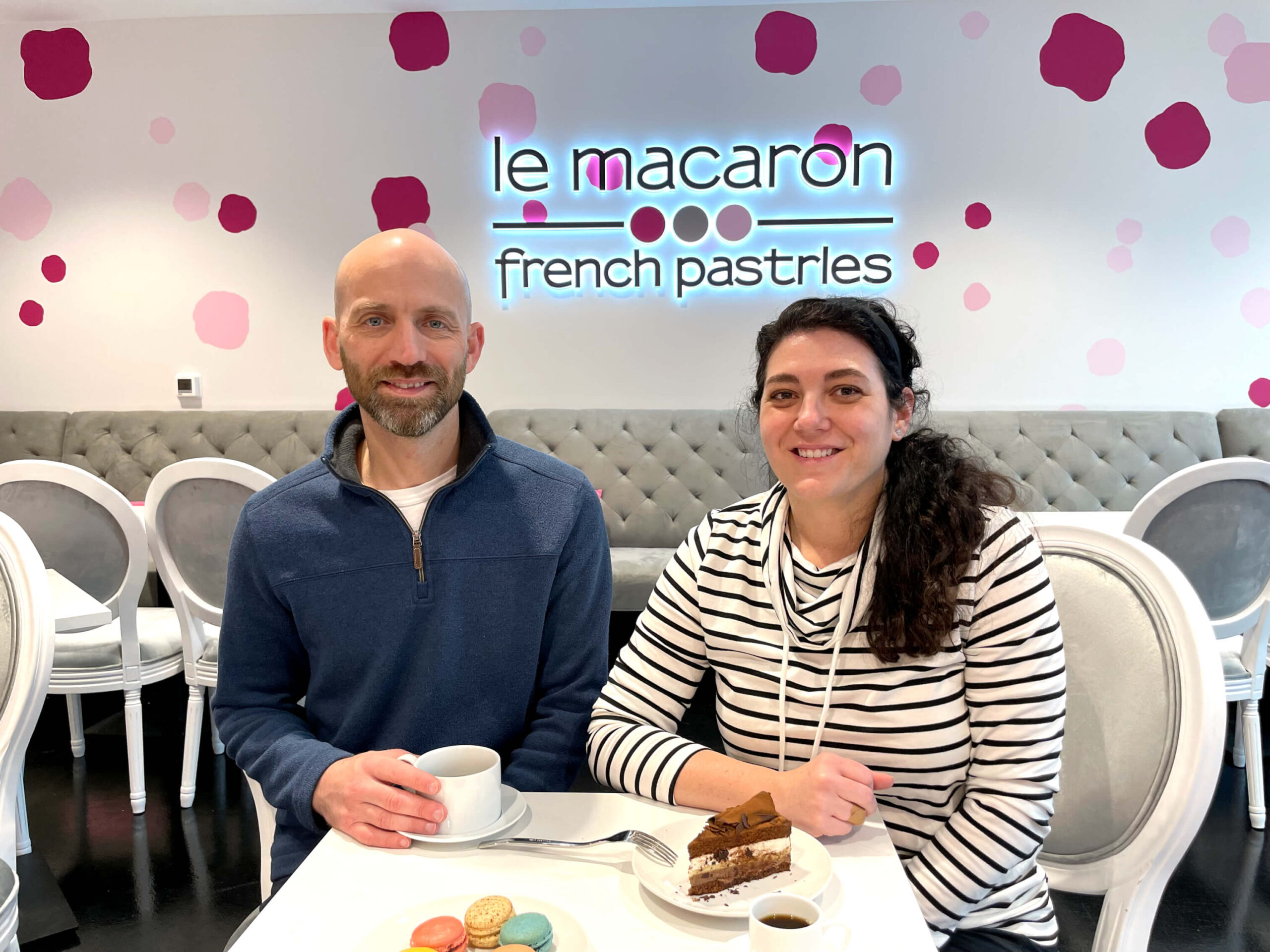 owners aaron parker and christi parker sitting at their le macaron cafe