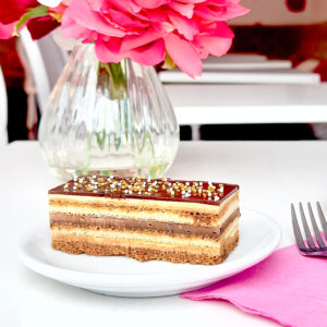 A classic French dessert! Layers of almond joconde sponge cake layered with decadent buttercream & chocolate ganache.