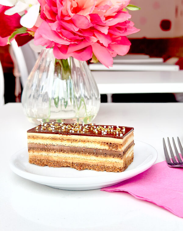 A classic French dessert! Layers of almond joconde sponge cake layered with decadent buttercream & chocolate ganache.