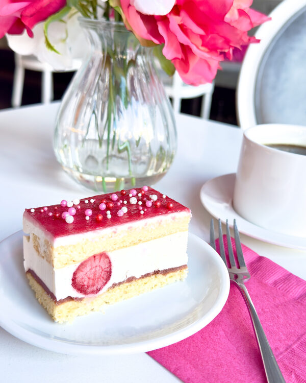 Delicate yellow cake layered with strawberry compote, silky vanilla mousse, and whole strawberries. 